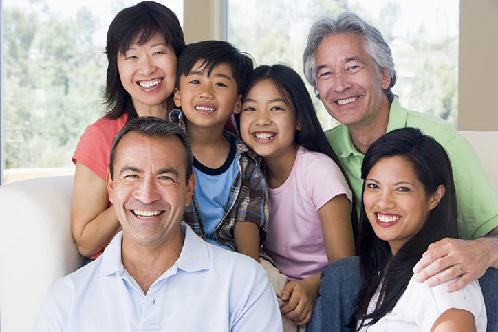 Multi-generational family in living room smiling