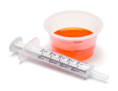 Liquid Medicine in Cup with Oral Syringe.