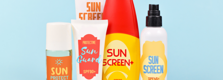 Different protective sun screen cream bottles and spray tubes with made up labels on light blue background