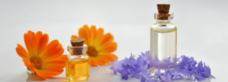 two orange flowers and two bottles