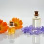 two orange flowers and two bottles